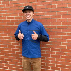 owenhouse cycling team member in troy lee designs shuttle jacket giving thumbs up
