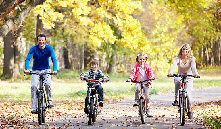 family on bikes in the autumn