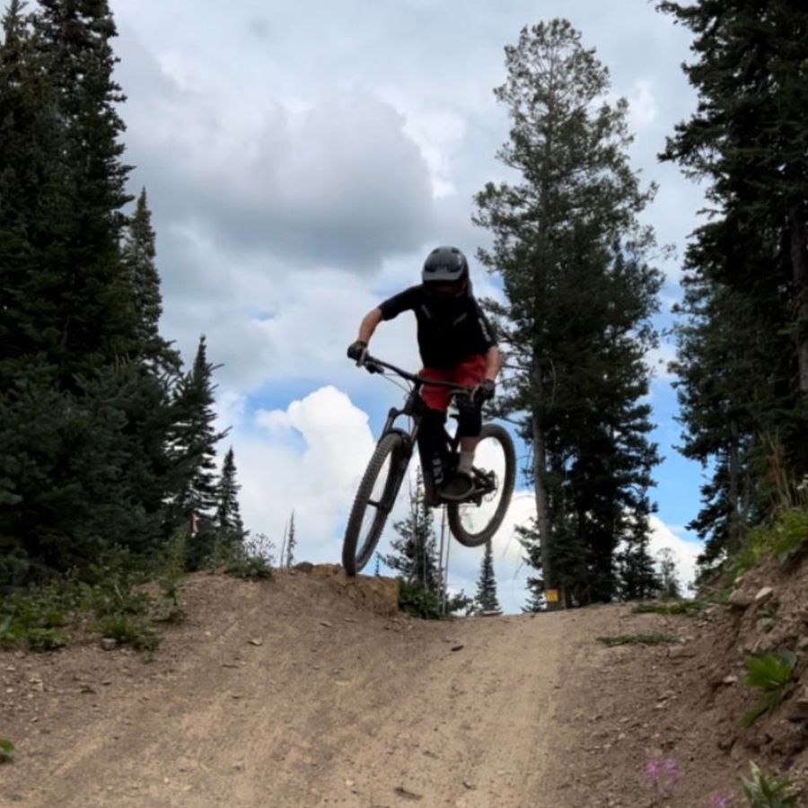 owenhouse cycling sales team member zach mitchell on a mountain bike jump