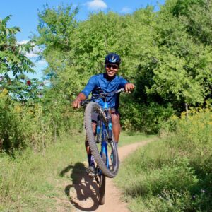 happy male riding a giant mountain biking on a trail