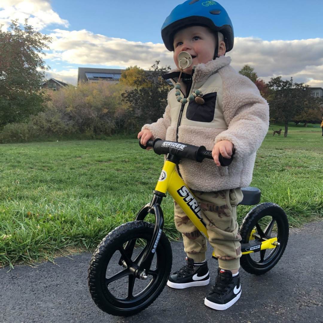 toddler on a strider bike