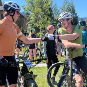 two mountain bikers fist bumping at the big sky biggie