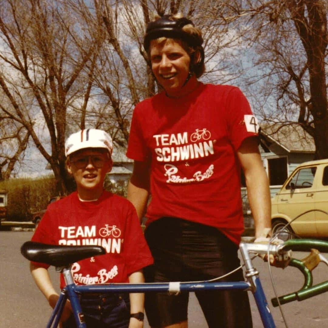 throwback photo of a parent and kid riding bikes with Team Schwinn shirts