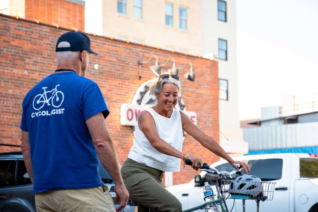 Bozeman bike tour guest getting set up with a rental bike at owenhouse cycling